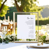 Framed bar menu on a table with outdoor setting