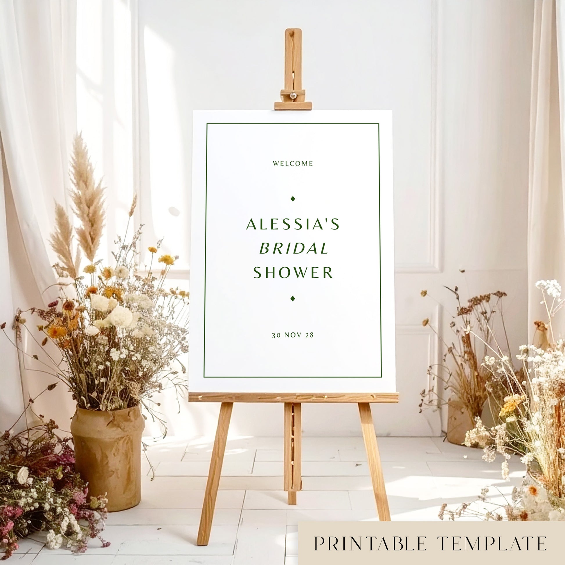 Minimal bridal shower welcome sign on an easel with floral arrangements in a room setting.