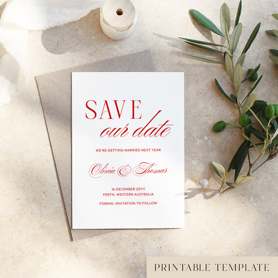 Heritage save the date card with red text on a light background with a spool of thread and olive branch.