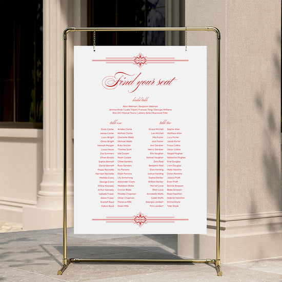 Heritage-style wedding seating chart template displayed on a gold stand against a neutral wall.