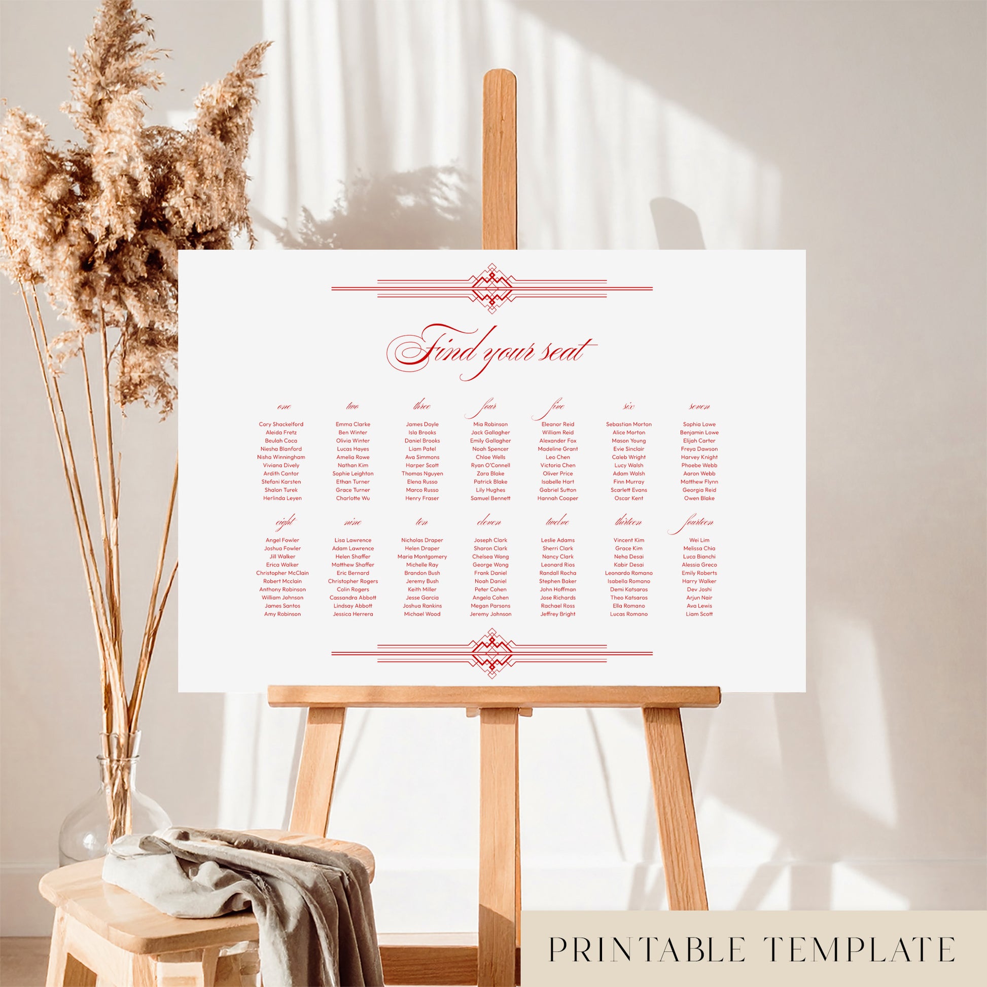 A horizontal printable wedding seating chart sign template displayed on a wooden easel with a decorative dried plant in the background.