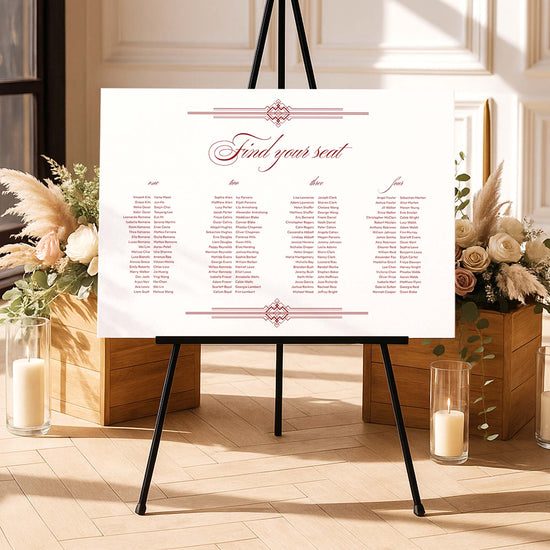 Old money style long tables seating chart template on an easel with floral arrangements and candles in a decorative setting.