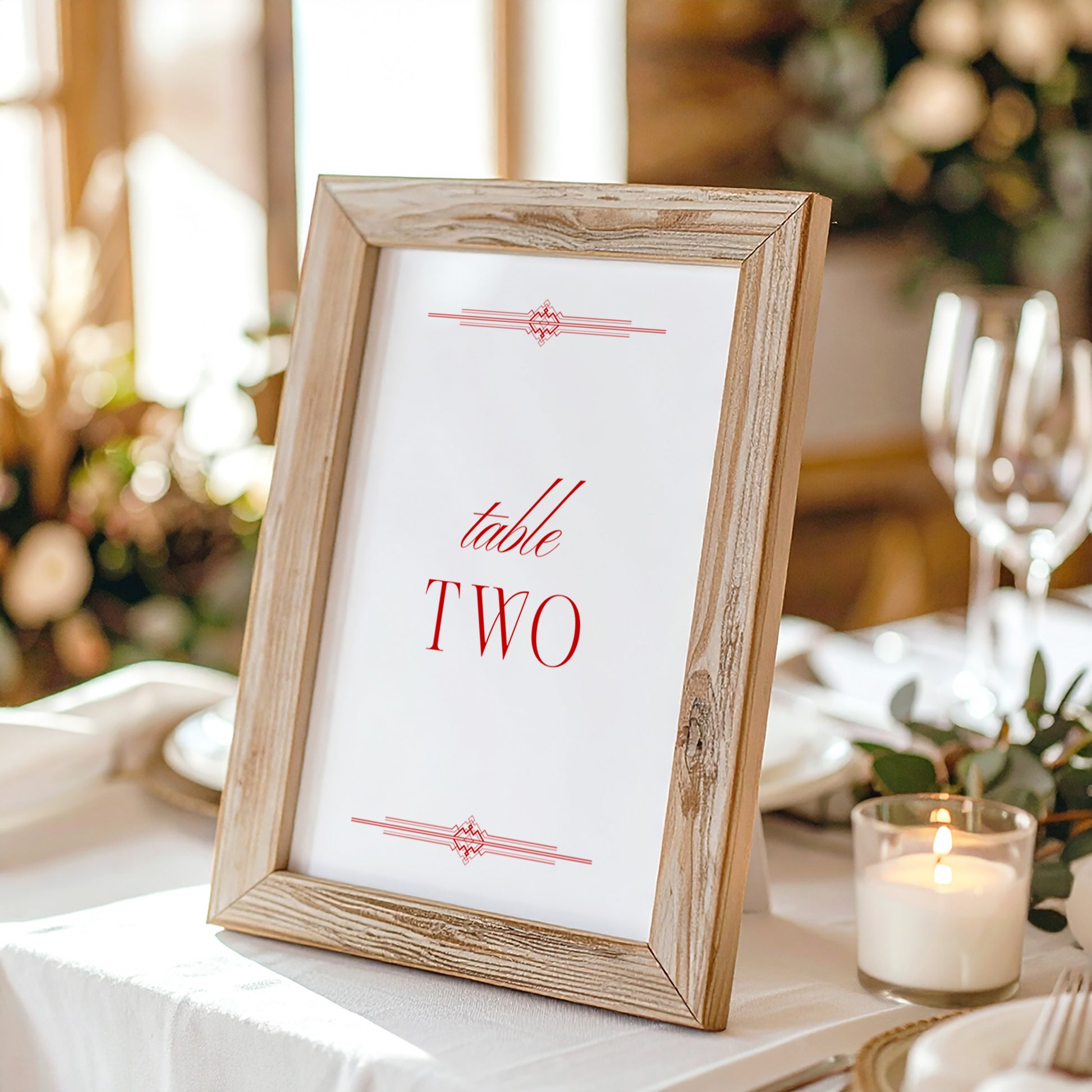 Wooden photo frame with a printed table on a table setting with candles and glasses.