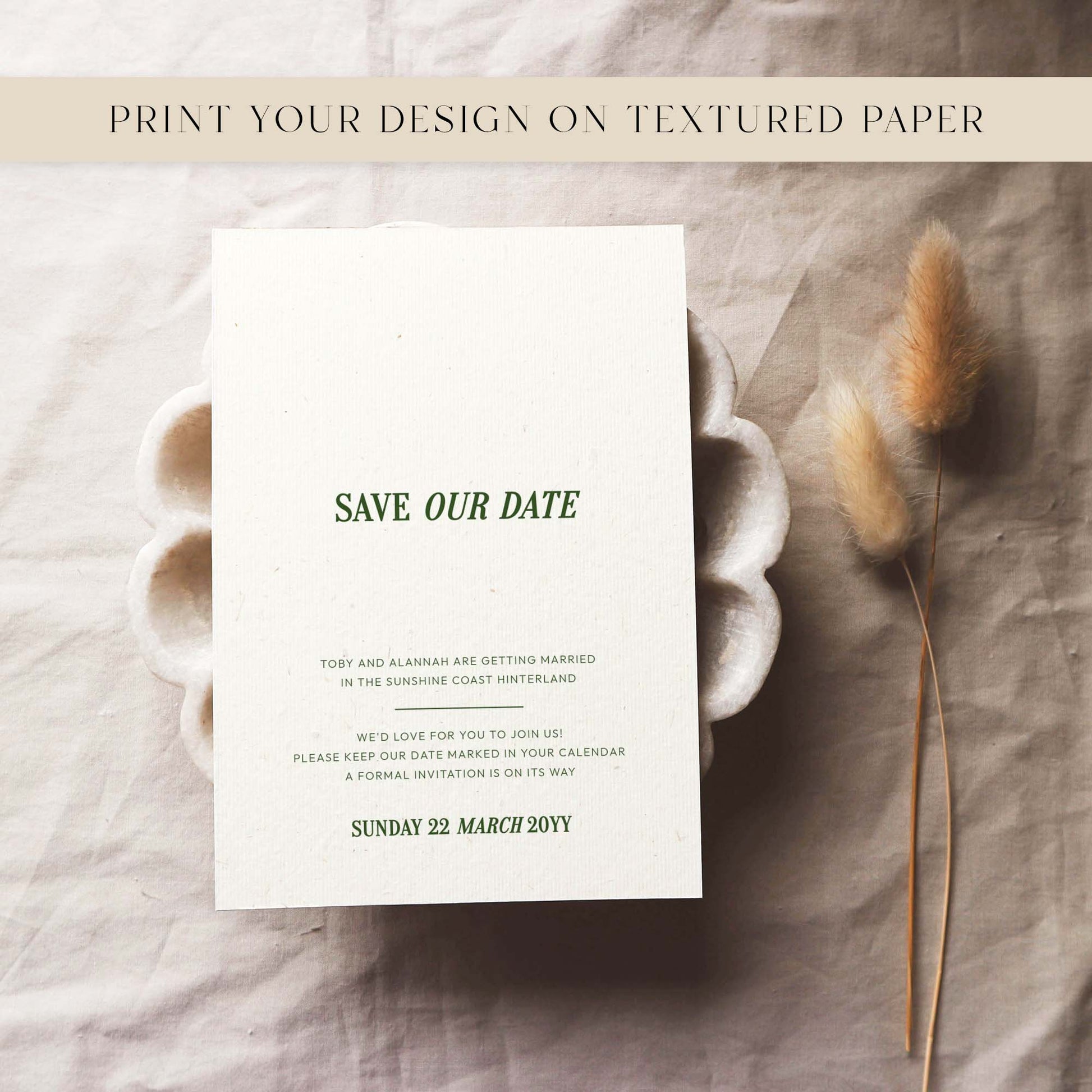 Save the date card on textured paper with dried plants.