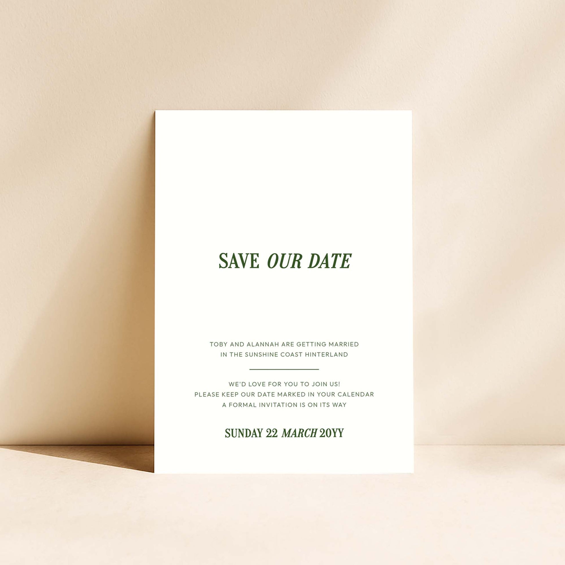 Minimal save the date card standing upright on a neutral background.