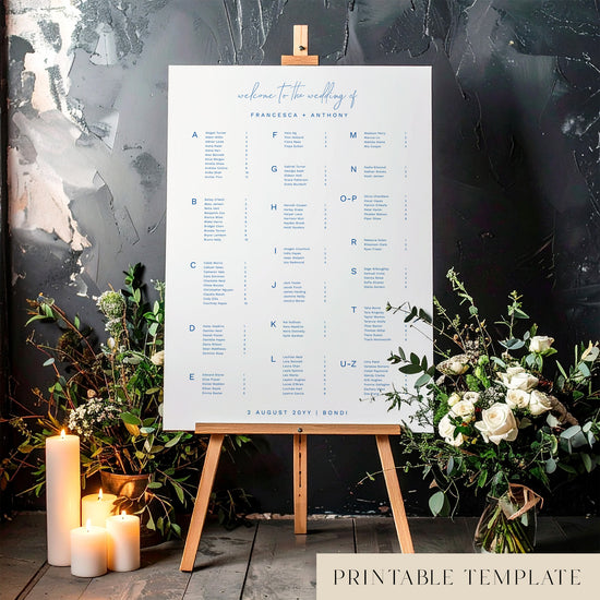 Printable minimal alphabetical wedding seating chart sign on an easel with floral arrangements in a room setting.