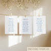 Three seating chart cards with printed names, clipped to a string with pegs, against a neutral background.