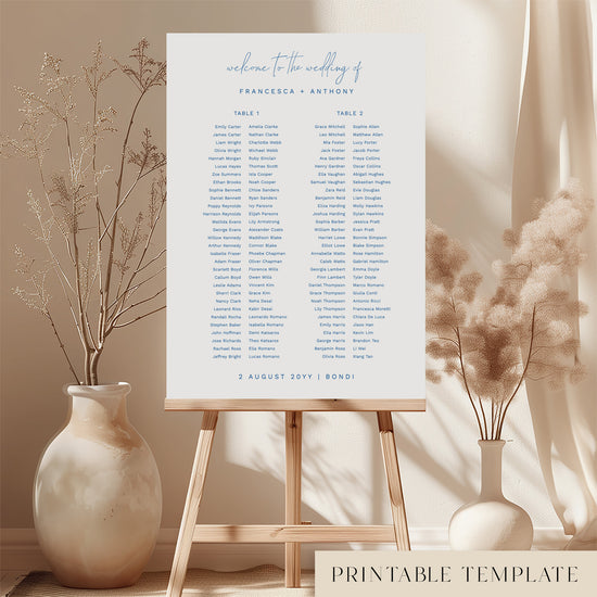 Printable minimal wedding seating chart sign on an easel with floral arrangements in a room setting.