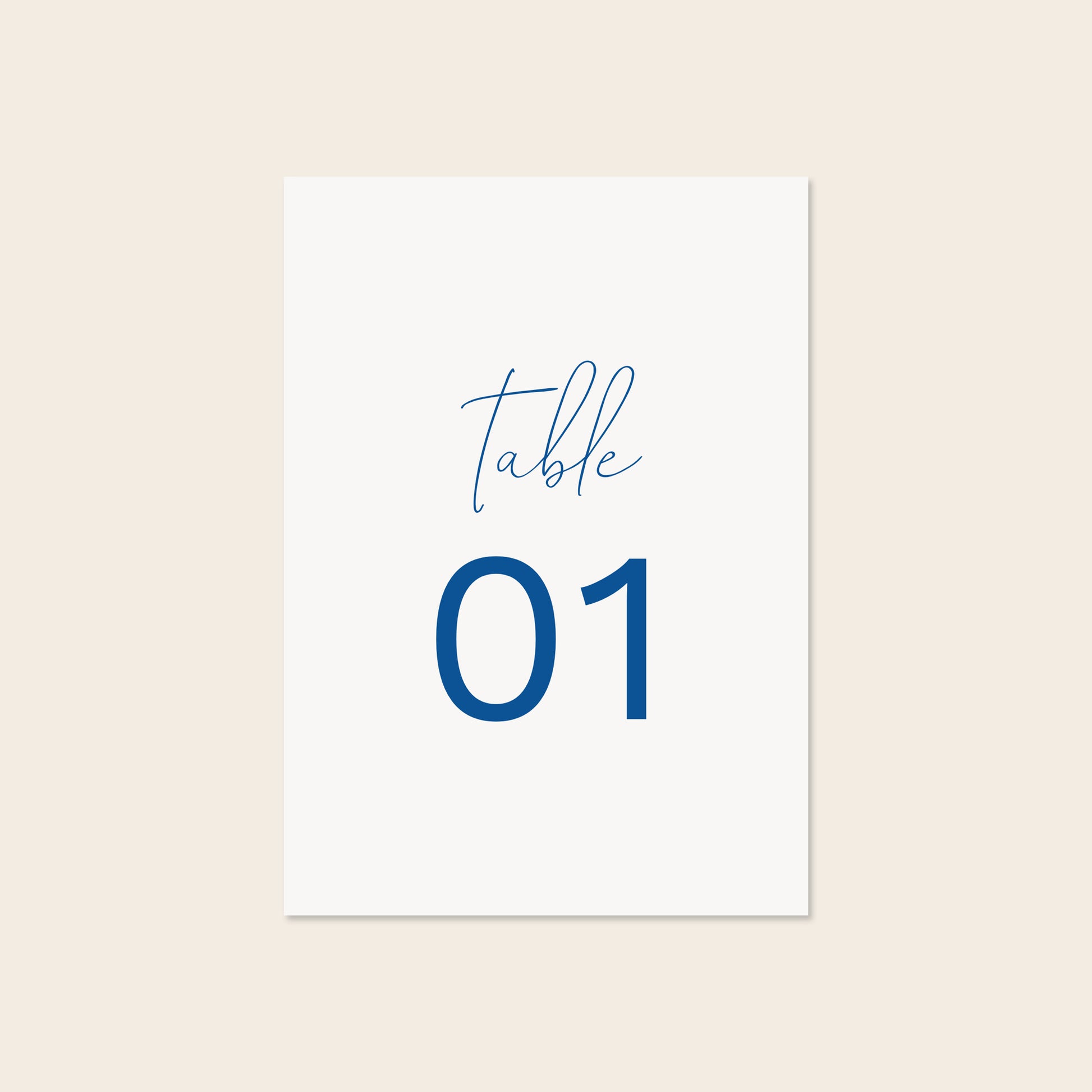 Wedding printable table number template design on a beige background.