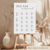 Printable alphabetical wedding seating chart sign on an easel with floral arrangements in a room setting.