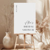 White printable bridal shower welcome sign template with floral decorations and a wooden easel.