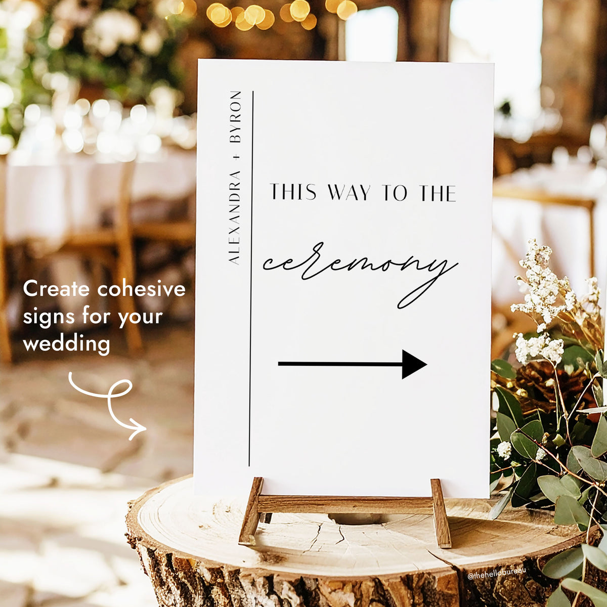 Printable wedding ceremony direction sign template with minimalist line accent, displayed on a wooden stand among greenery and fairy lights.
