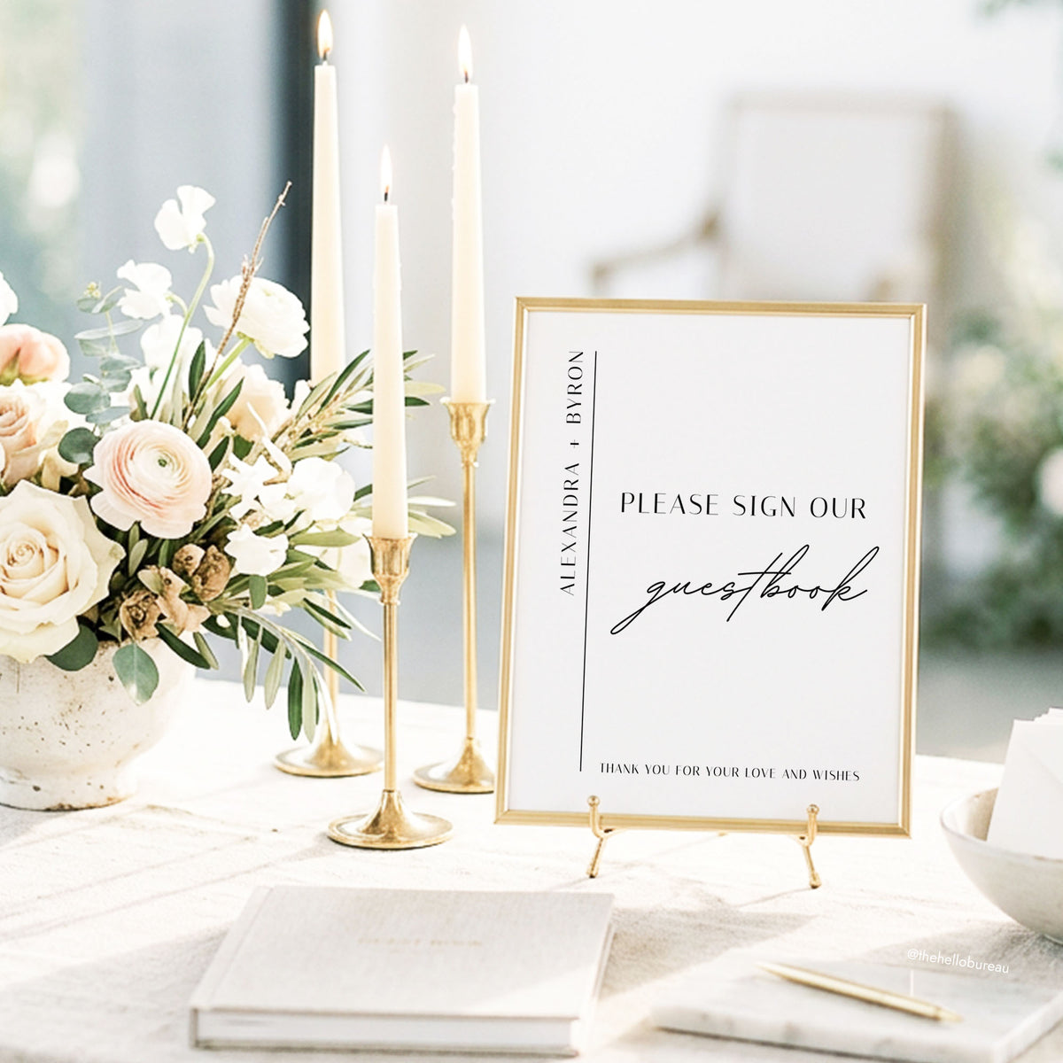 DIY wedding guestbook sign template in a minimalist design, framed in gold and styled with taper candles and blush florals.