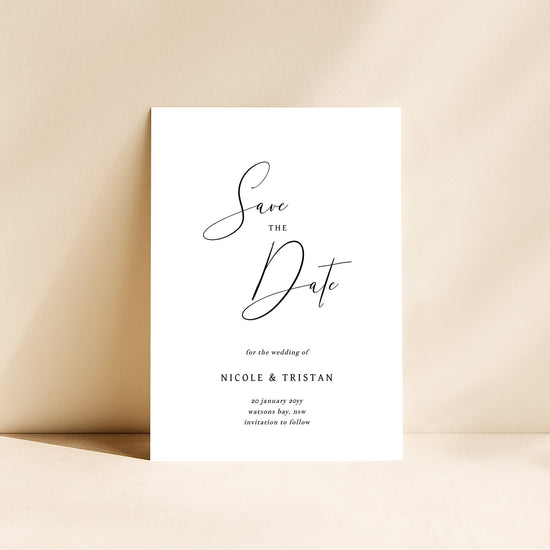Minimal save the date card standing upright on a neutral background.