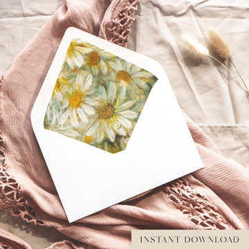 Printable white daisy envelope liner for 5x7 wedding invitations, with painted daisies in cream, golden yellow and sage green, shown inside a white envelope on dusty pink fabric.