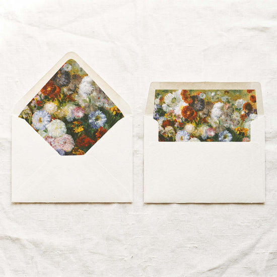 DIY fine art wedding envelope liners in a euro flap and a straight flap, with painted white, periwinkle blue and rust orange florals, for 5x7 wedding invitations.