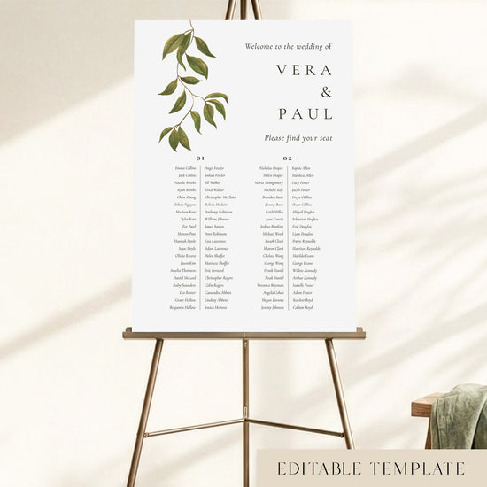 A 2-long-table wedding seating chart displayed on an easel, with hand-painted greenery and guest names