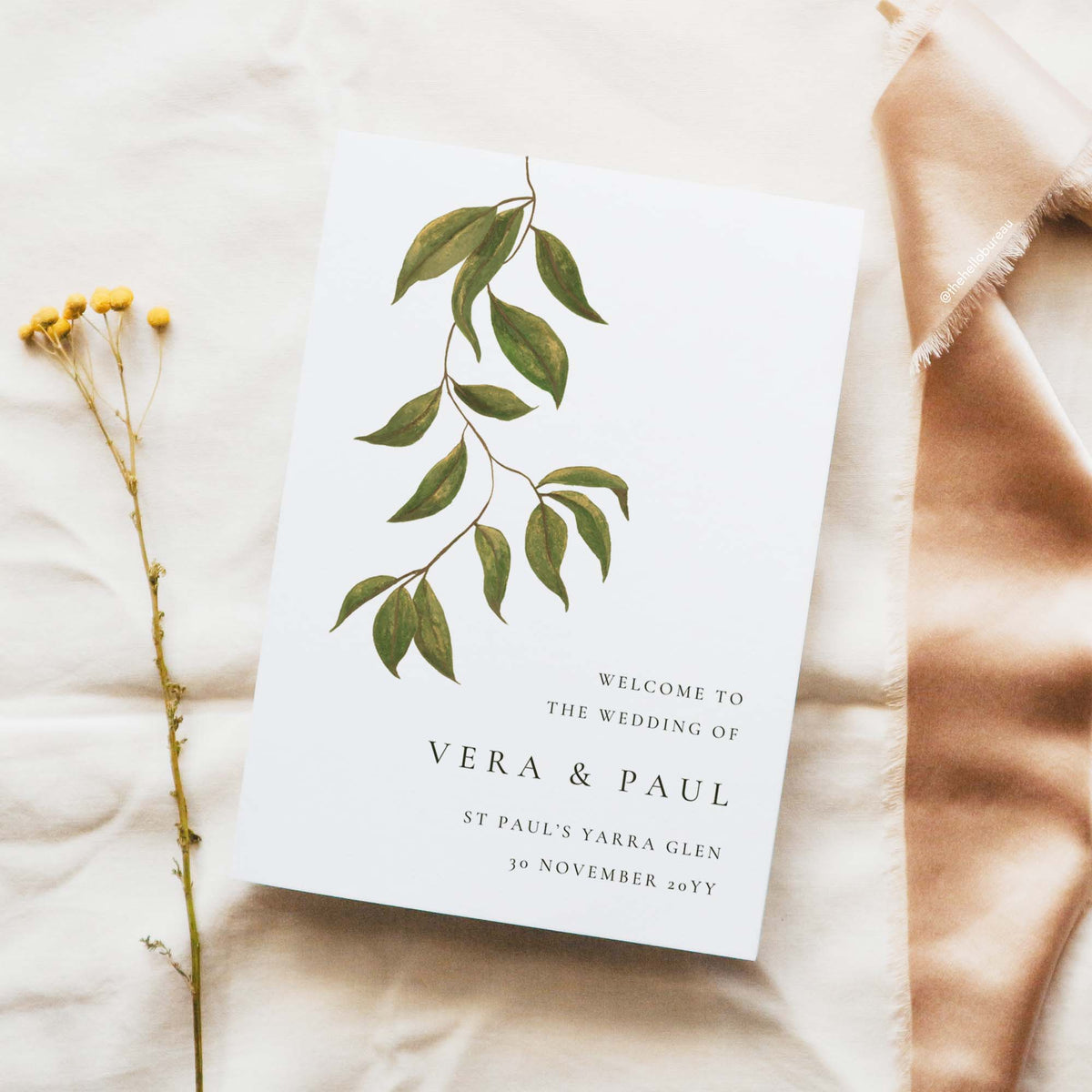 Catholic order of service booklet cover featuring hand-painted botanical leaves, couple's names and cathedral details