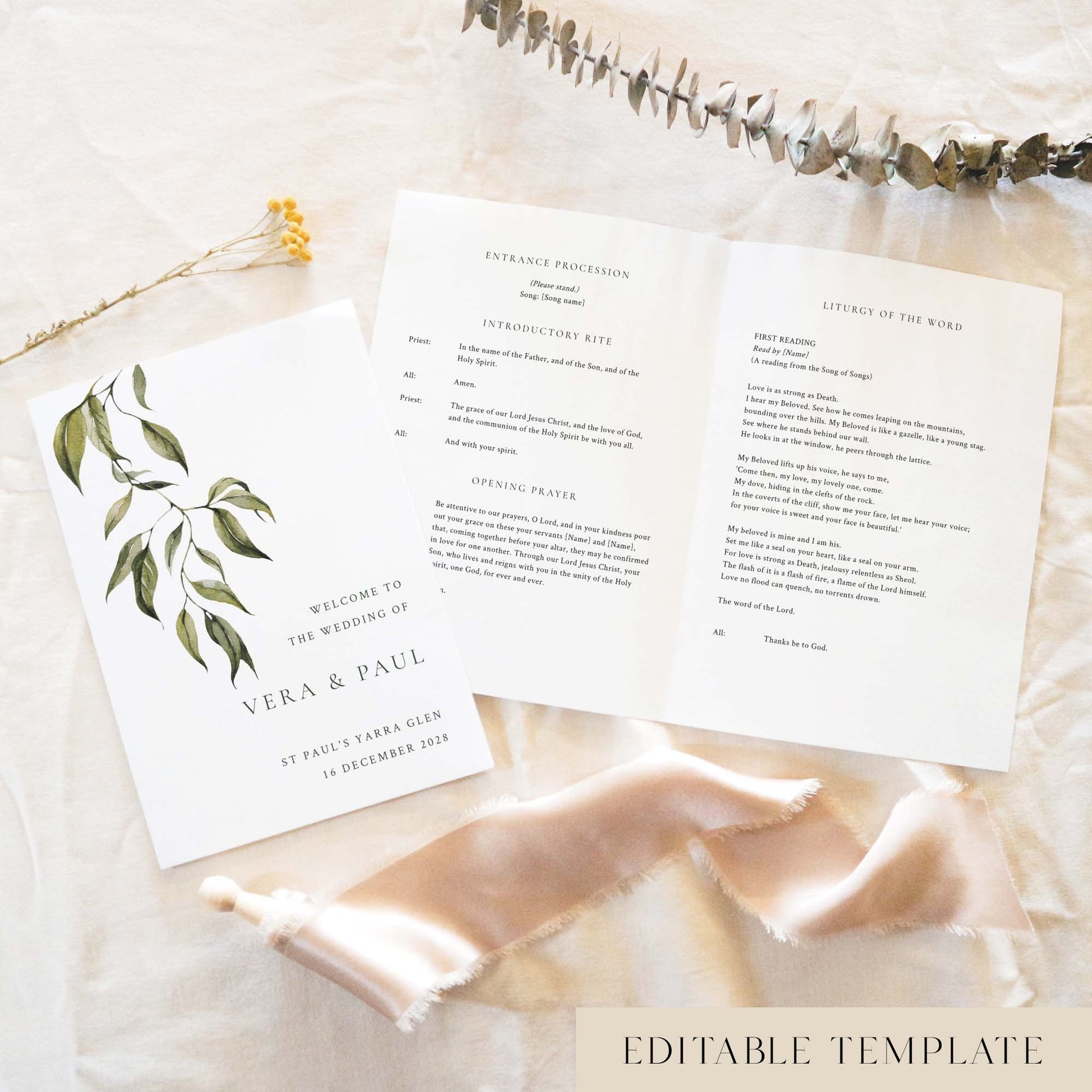 A5 wedding Mass ceremony booklet shown open with the cover beside it, styled on light fabric with dried florals and a soft ribbon.