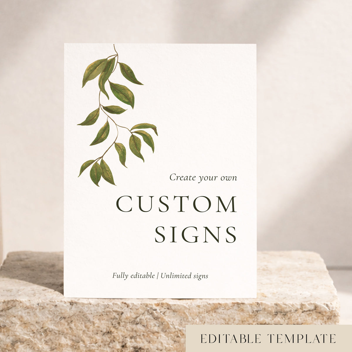 Botanical Evergreen editable wedding signs template with a hand-painted green leaf branch on a white custom sign, styled on a cream stone block. DIY and Canva friendly.