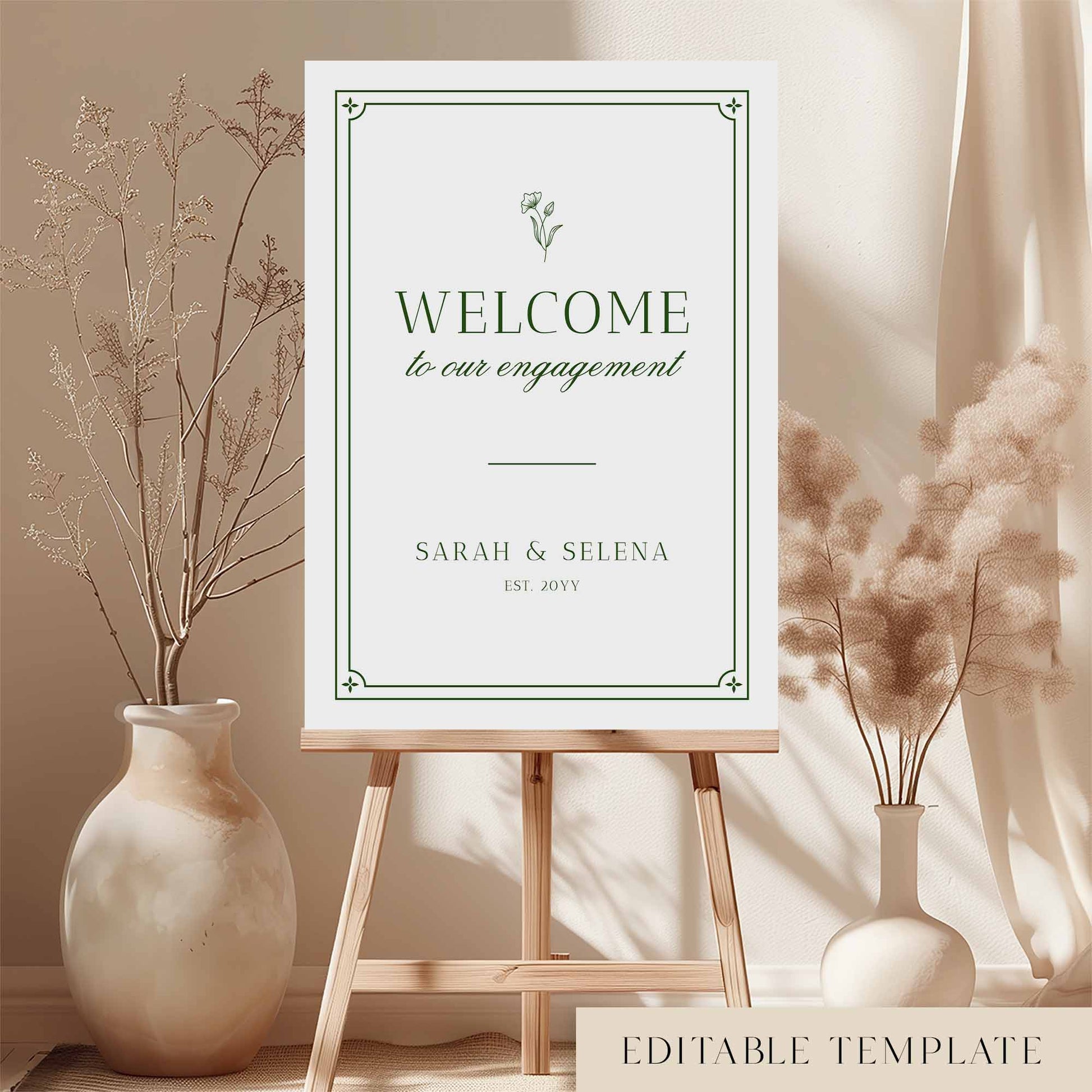 Botanical engagement party welcome sign on an easel with floral arrangements in a room setting.