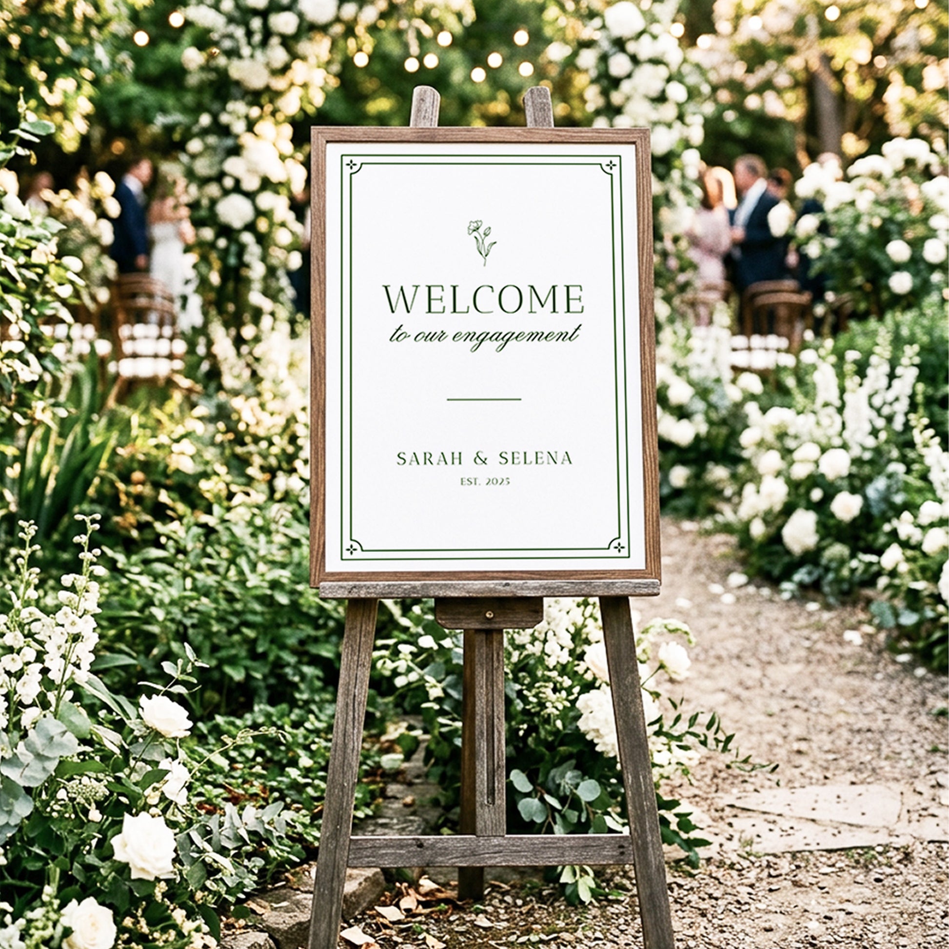 Elegant greenery engagement party welcome sign displayed in a timber frame on a wooden easel