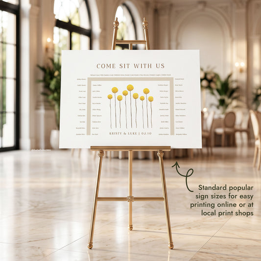 Customisable 46-guest horseshoe seating chart template with hand-painted yellow billy button wildflowers, displayed on a gold easel in a marble hall.