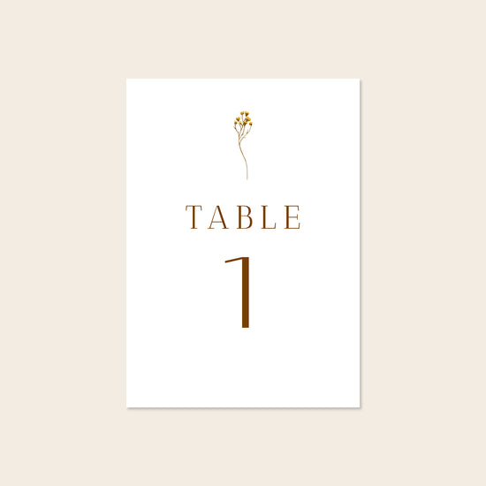 Wedding printable table number template design on a beige background.