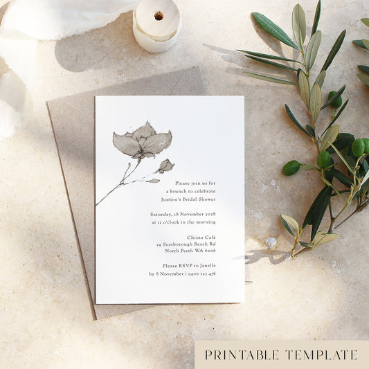 Bridal Shower invitation card with wabi-sabi floral design on a textured surface with olive branches.