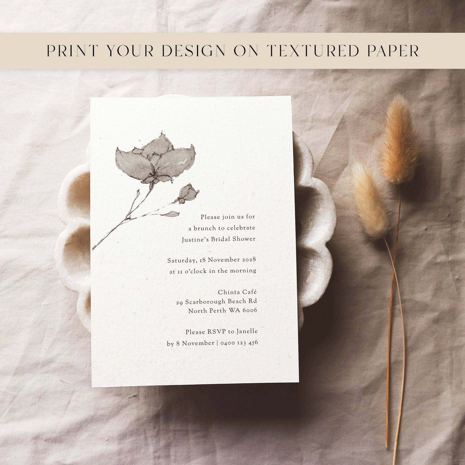 Bridal shower invitation card with floral design on textured paper