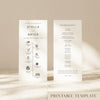 Two DL-sized wedding program cards standing upright on a textured surface with soft natural light creating shadows across the background.
