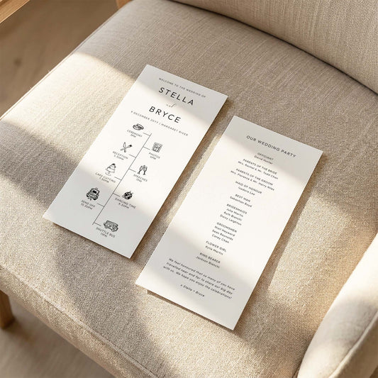 Two DL-sized wedding program cards laid flat on a cushioned chair with sunlight streaming across the linen fabric.