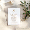 Bridal shower invitation card with floral design on a textured surface with olive branches.