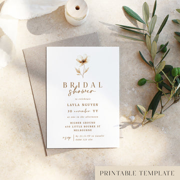 Bridal shower invitation card with floral design on a textured surface with olive branches.