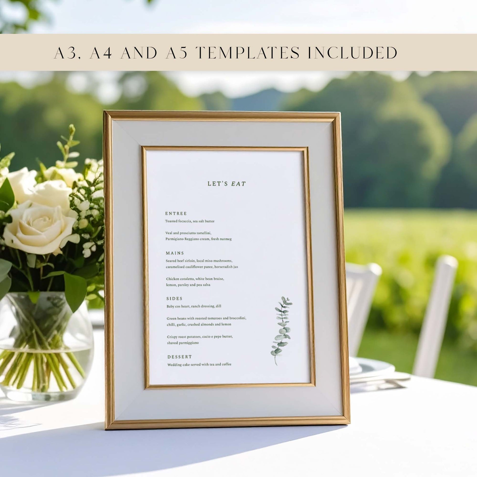Framed wedding menu with floral arrangement on a table at an outdoors wedding.