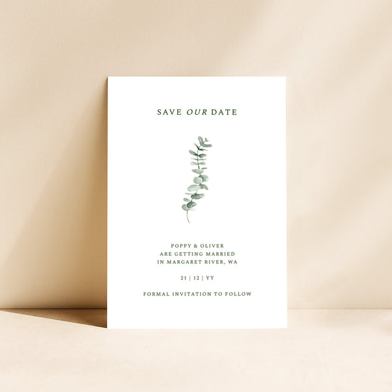 Save the date card with eucalyptus design on a beige background.