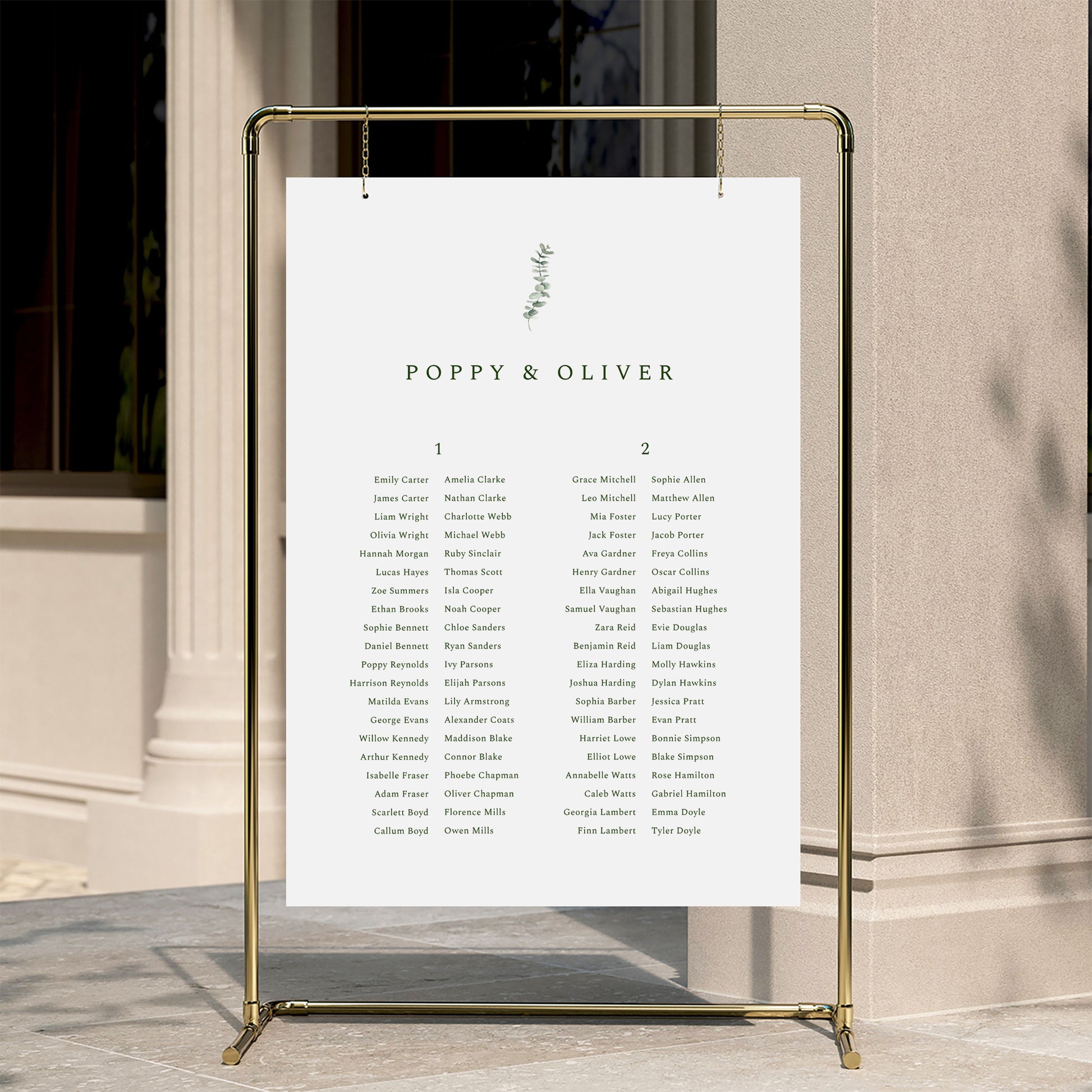 Minimal wedding seating chart template displayed on a gold stand against a neutral wall.