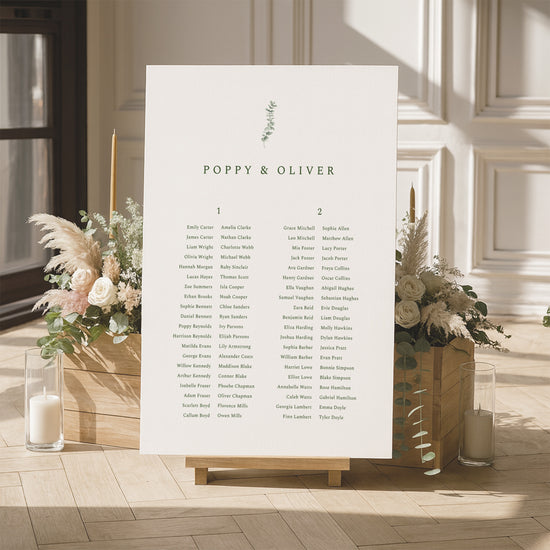 Minimal seating chart for a wedding with floral arrangements and candles in a room.