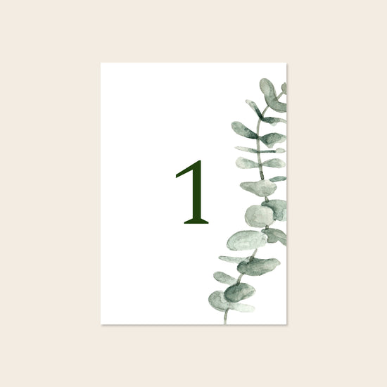 Wedding printable table number template design on a beige background.