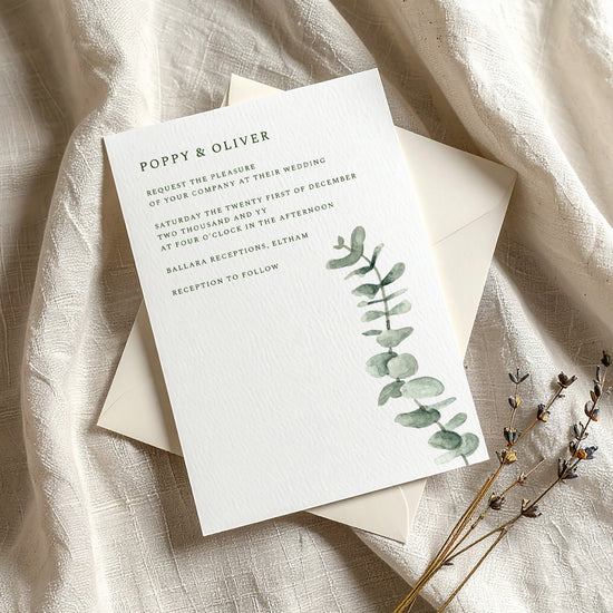 Greenery wedding invitation template with eucalyptus design on a textured fabric background.