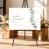 Modern welcome sign template on an easel with floral arrangements and candles in a decorative setting.