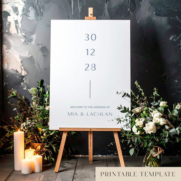 Printable minimal wedding welcome sign on an easel with floral arrangements in a room setting.