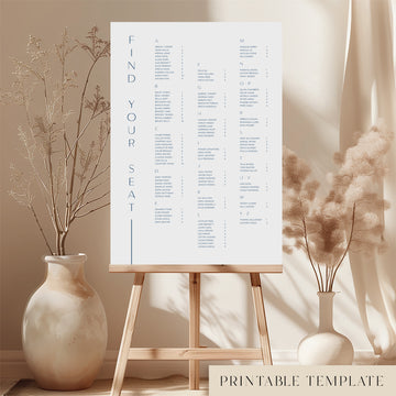Printable alphabetical wedding seating chart sign on an easel with floral arrangements in a room setting.