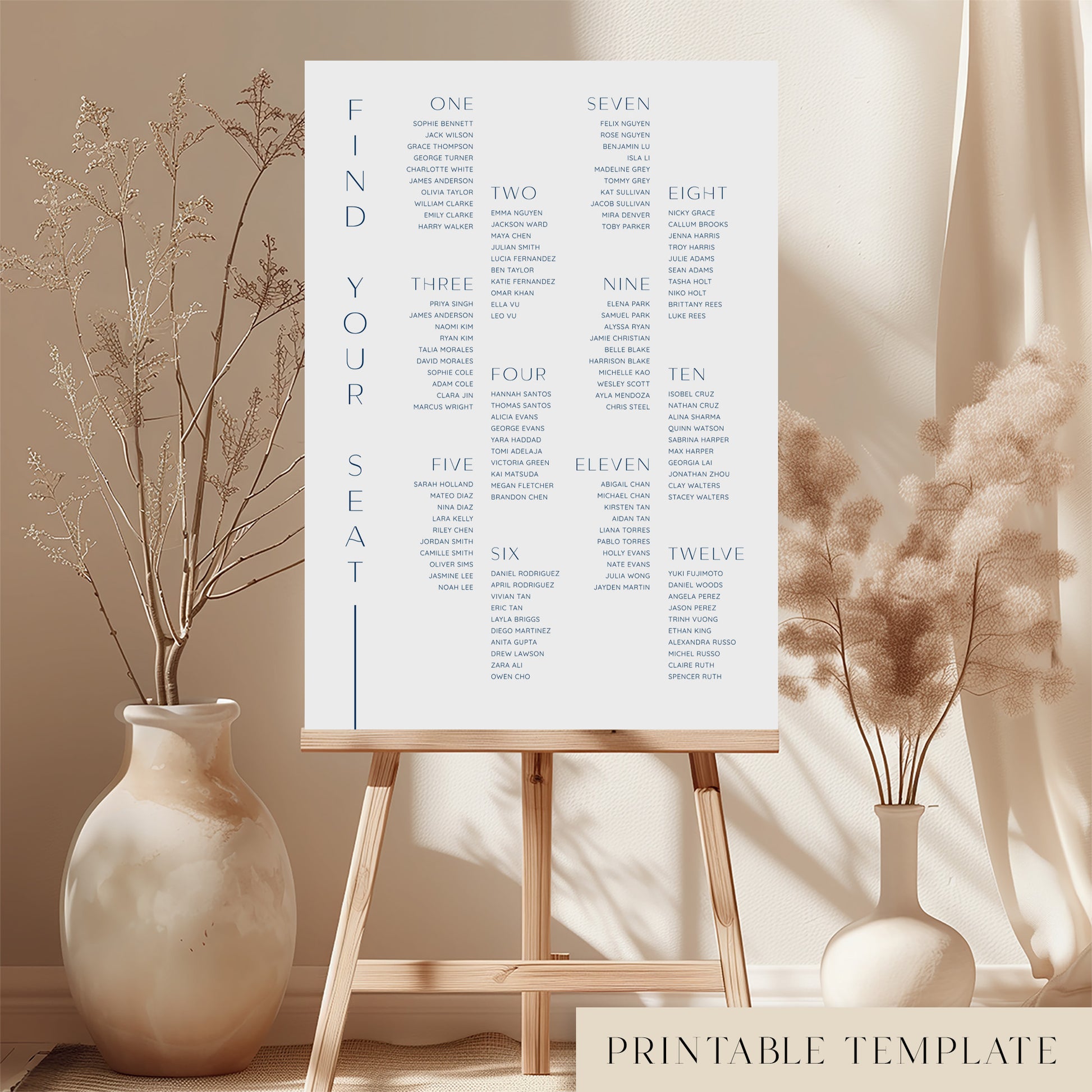 Printable minimal wedding seating chart sign on an easel with floral arrangements in a room setting.