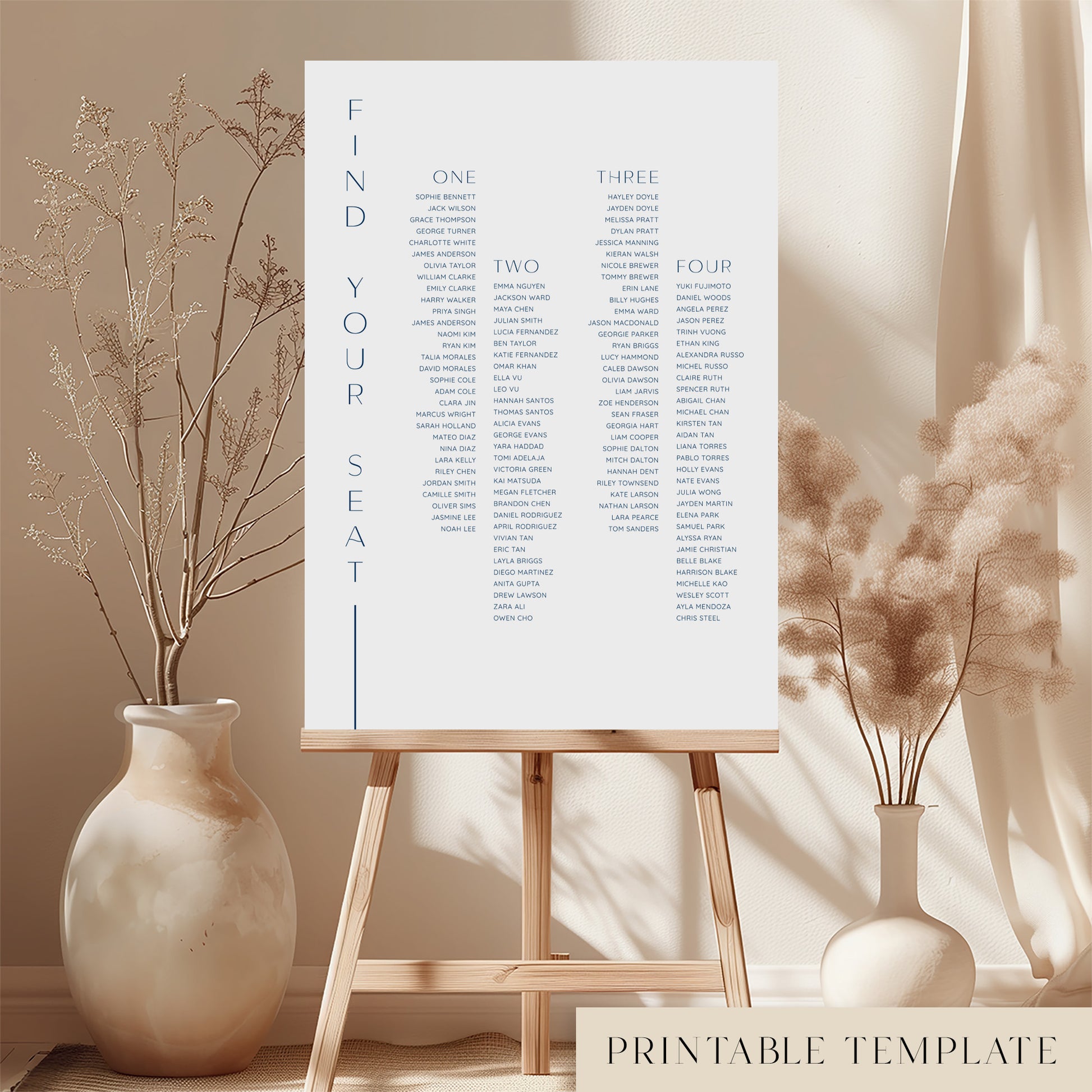 Printable long tables wedding seating chart sign on an easel with floral arrangements in a room setting.