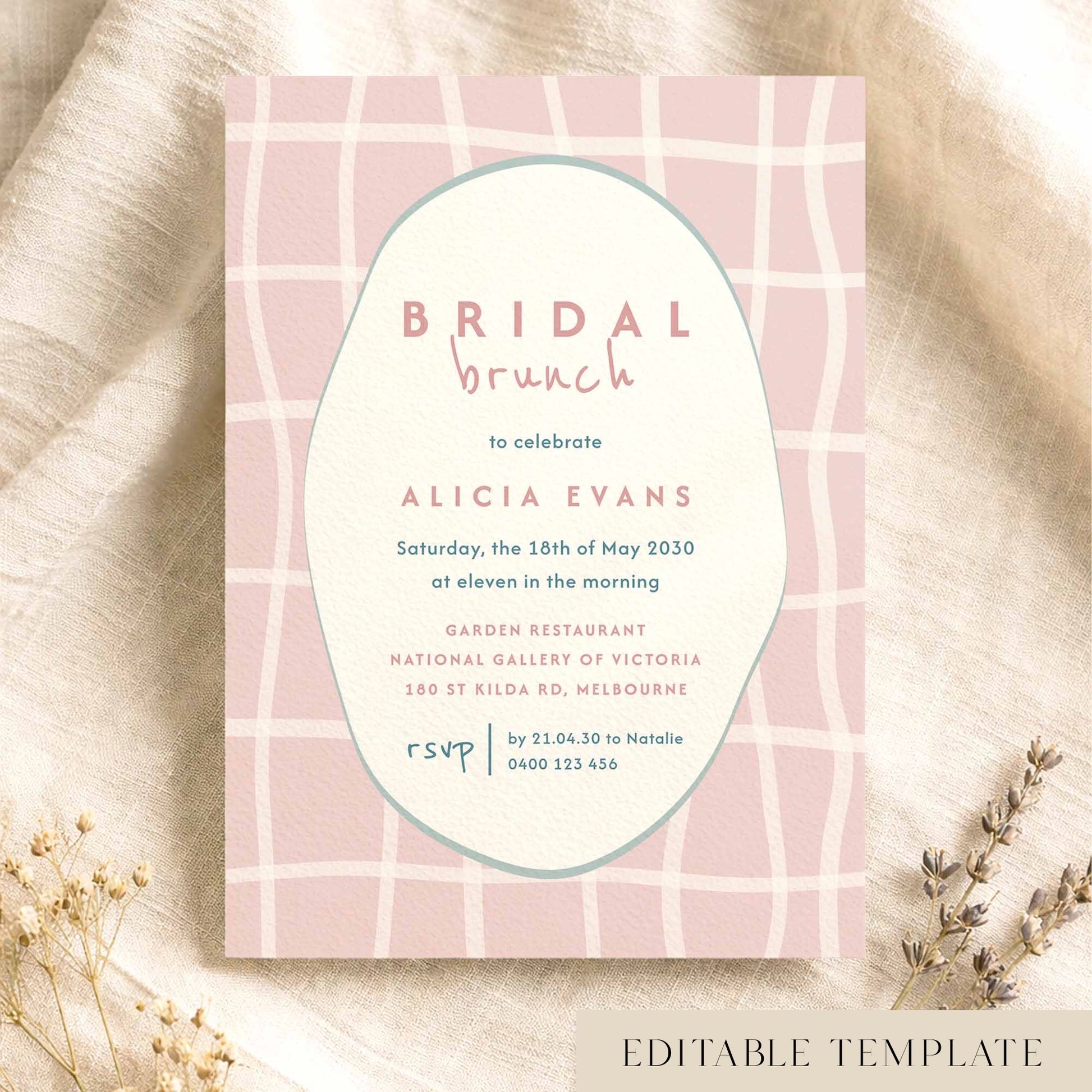 Whimsical pink bridal shower invitation template on textured card on fabric background.