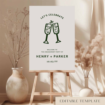 Whimsical engagement party welcome sign on an easel with floral arrangements in a room setting.