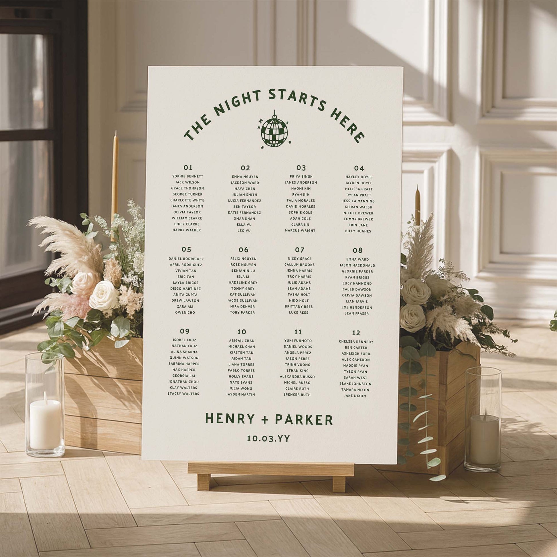 Large wedding seating chart with floral arrangements and candles in a room setting.