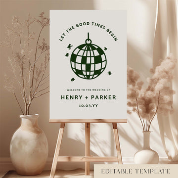 Printable wedding welcome sign template featuring a bold disco ball icon and curved retro typography, styled on an easel with soft floral arrangements in a neutral room setting.