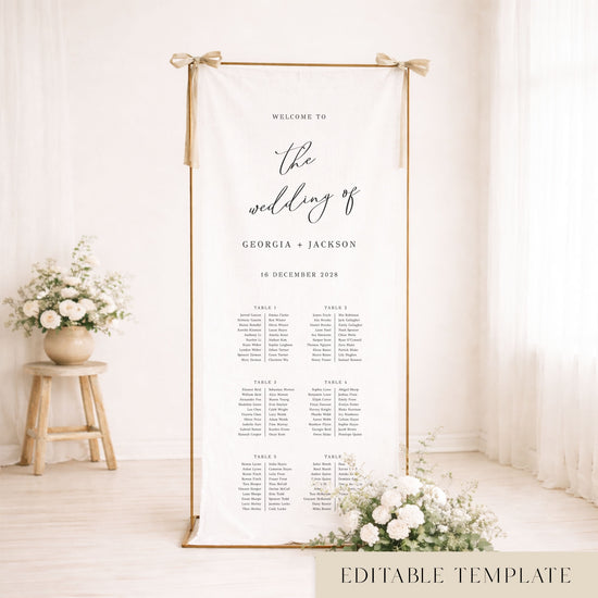 Gold frame with a hanging white linen wedding seating chart.
